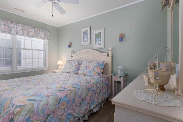 bedroom featuring wood-type flooring, ceiling fan, and crown molding