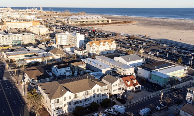 birds eye view of property featuring a water view and a beach view