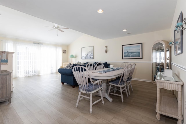 dining area with vaulted ceiling, hardwood / wood-style floors, and ceiling fan