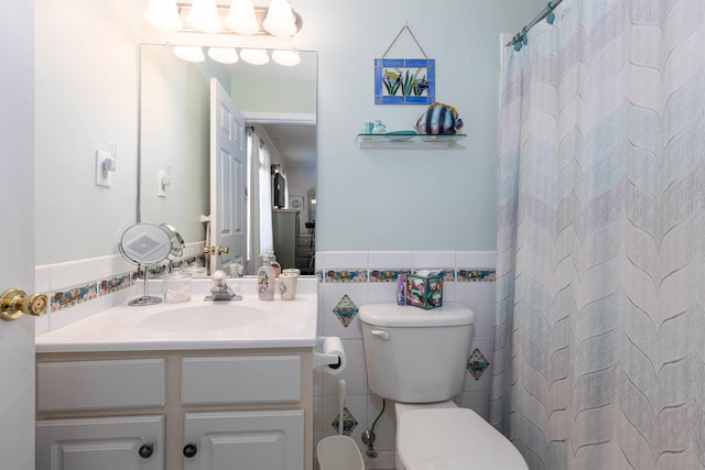 bathroom featuring a shower with curtain, vanity, toilet, and tile walls