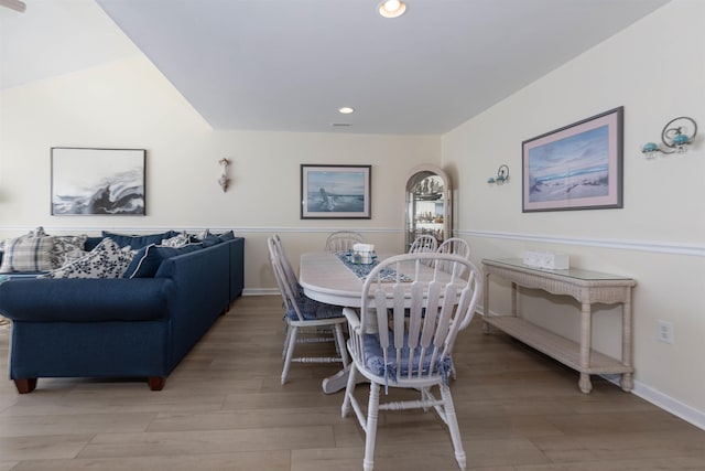 dining space with hardwood / wood-style floors