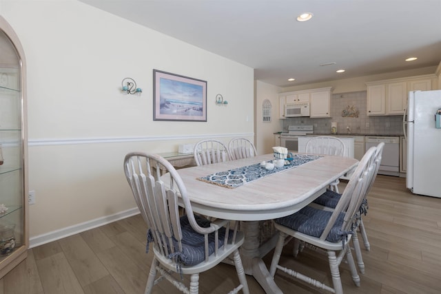 dining room with light wood-type flooring