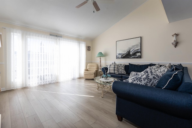 living room with high vaulted ceiling, ceiling fan, and light wood-type flooring