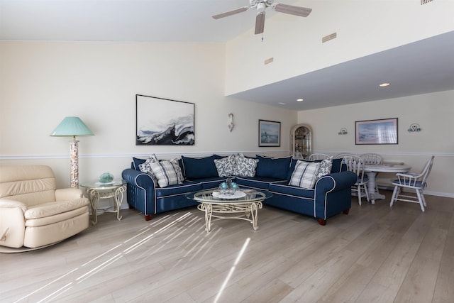 living room with high vaulted ceiling, hardwood / wood-style floors, and ceiling fan