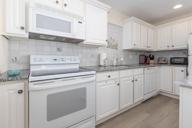 kitchen featuring sink, white cabinets, white appliances, and light hardwood / wood-style floors