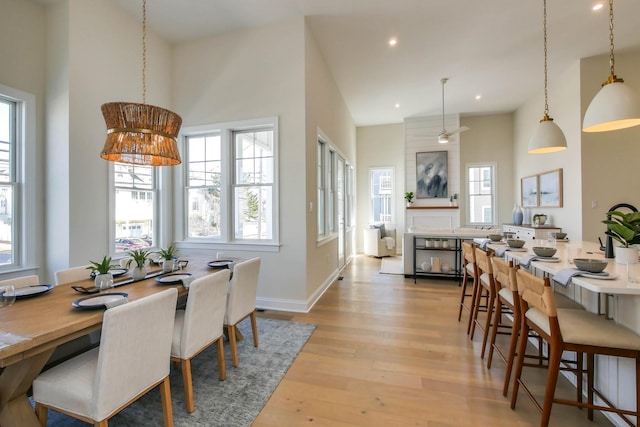 dining space featuring recessed lighting, a healthy amount of sunlight, light wood-type flooring, and baseboards