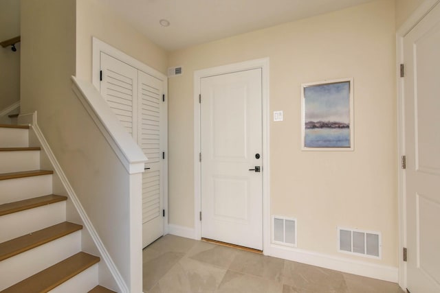 entryway featuring visible vents and stairway