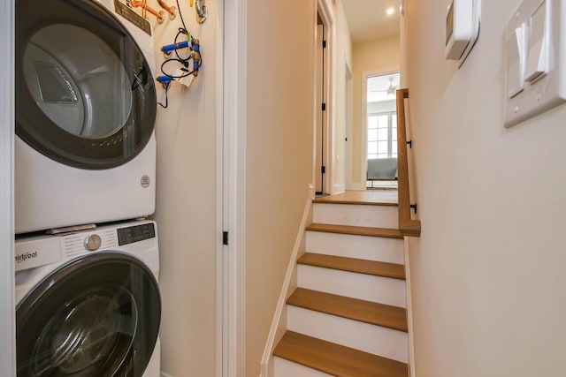 laundry area featuring stacked washer and clothes dryer and laundry area