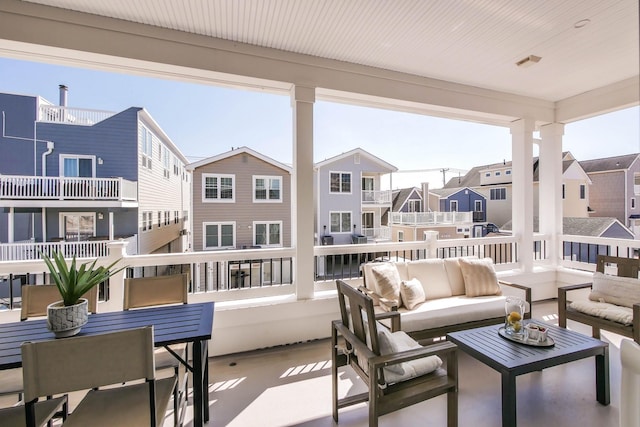 sunroom featuring a residential view