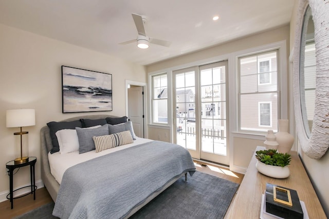 bedroom featuring visible vents, multiple windows, baseboards, and access to outside