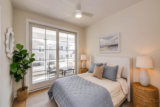 bedroom featuring baseboards, wood finished floors, a ceiling fan, and access to outside