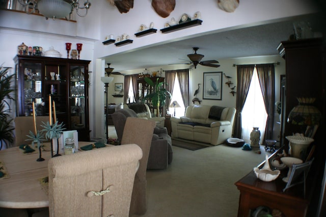 carpeted living room with ceiling fan and a healthy amount of sunlight