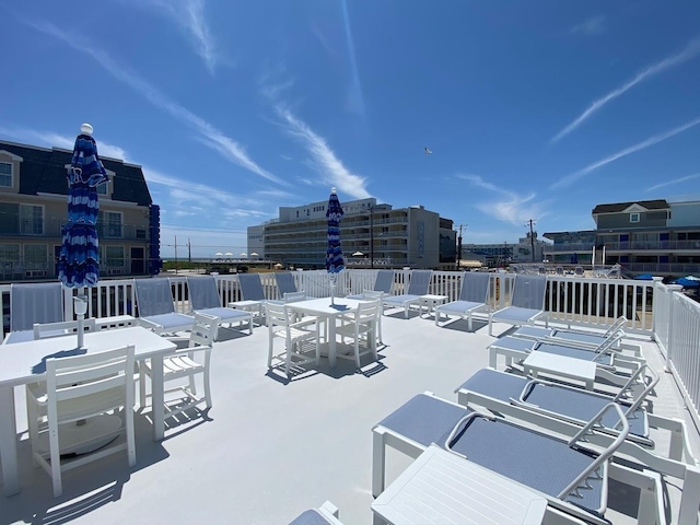 view of patio featuring a view of city and outdoor dining space