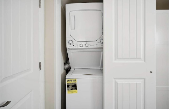 laundry area with laundry area and stacked washer / dryer