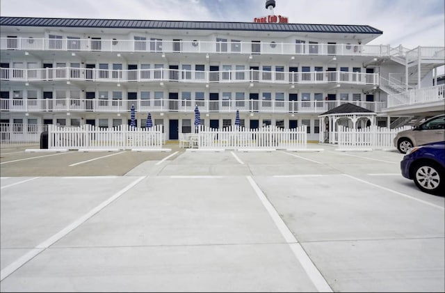 view of property featuring uncovered parking and fence