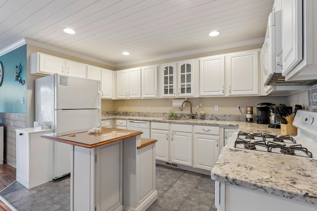 301 E Leaming Ave Unit A, Wildwood, NJ 08260 - kitchen with white appliances, a center island, white cabinets, recessed lighting, and ornamental molding