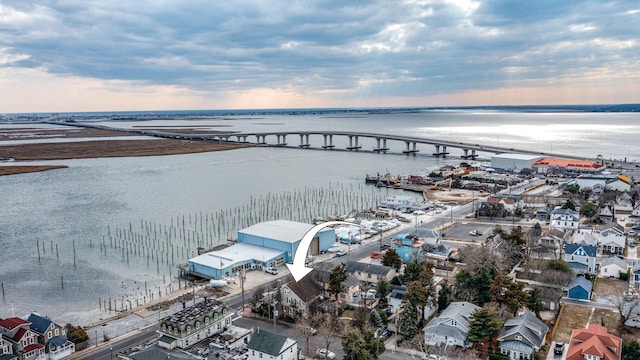 aerial view at dusk featuring a water view