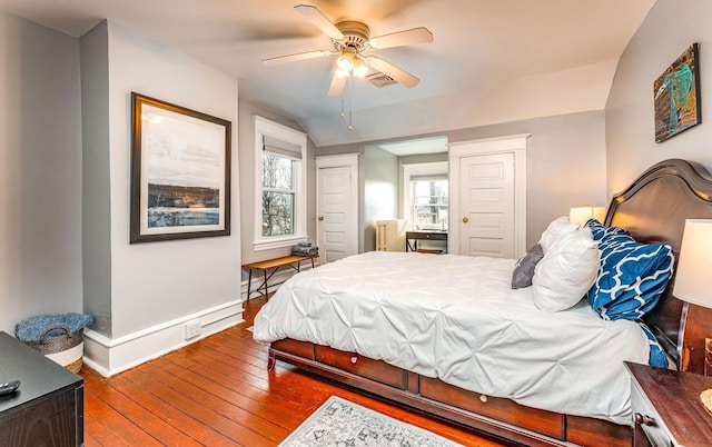 bedroom featuring ceiling fan, wood-type flooring, radiator heating unit, and vaulted ceiling