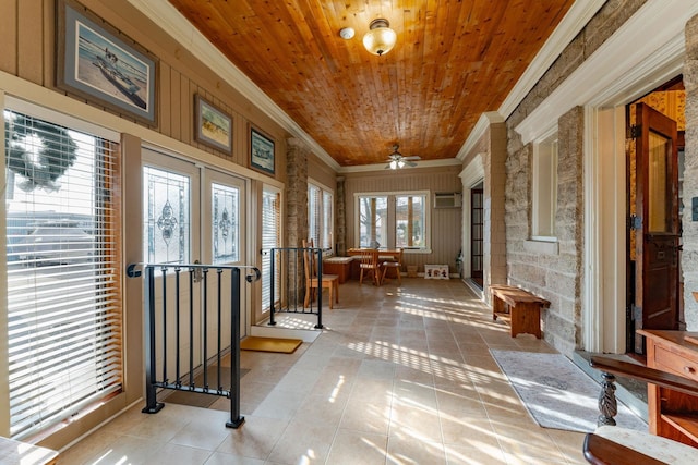 interior space with ceiling fan, french doors, wooden ceiling, and ornamental molding