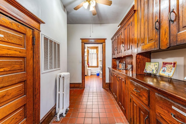 hall featuring radiator heating unit and light tile patterned floors