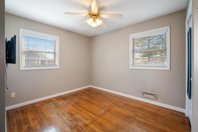 unfurnished room with baseboards, visible vents, and a healthy amount of sunlight