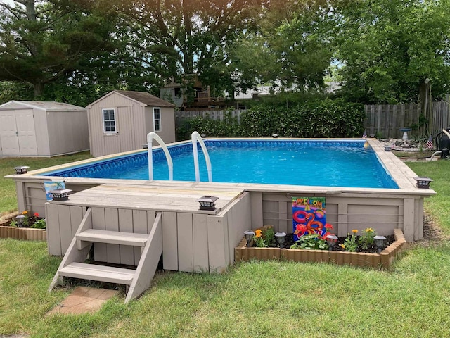 view of swimming pool featuring a storage unit, an outdoor structure, fence, and a fenced in pool