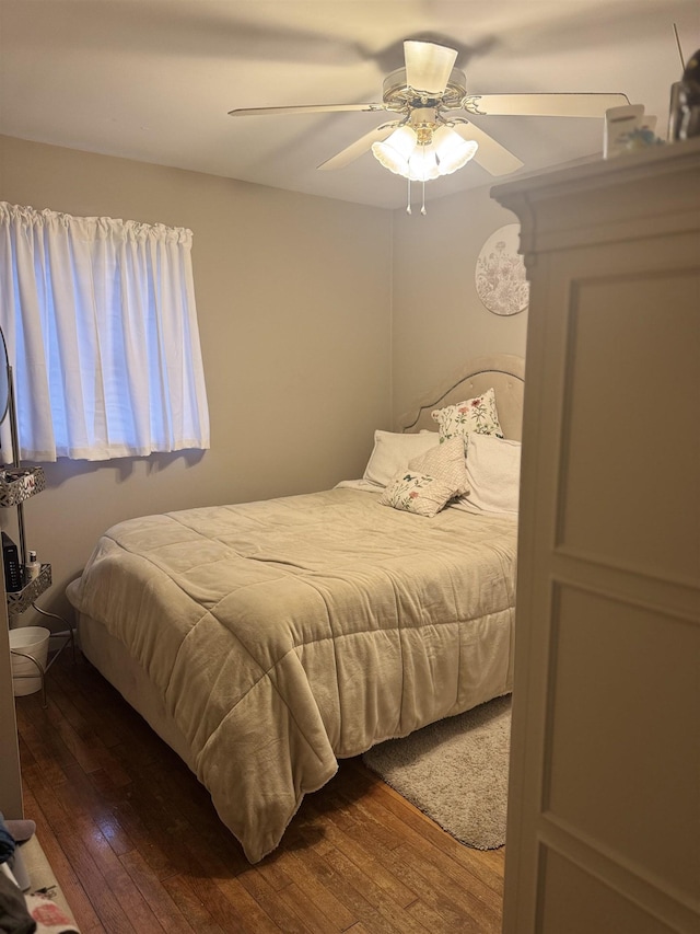 bedroom featuring a ceiling fan and hardwood / wood-style flooring