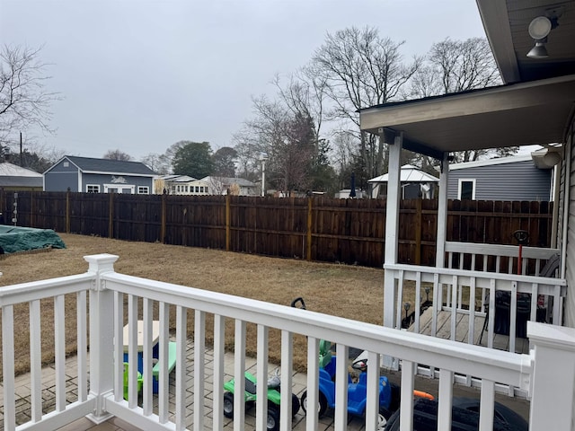 wooden terrace featuring a fenced backyard