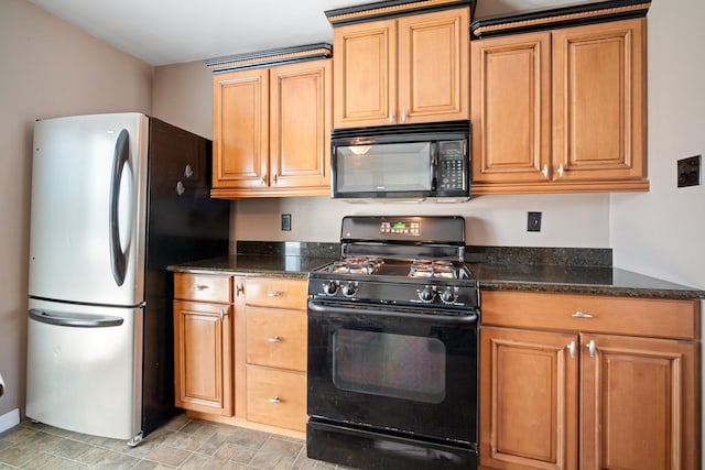 kitchen featuring dark stone countertops, black appliances, and brown cabinetry