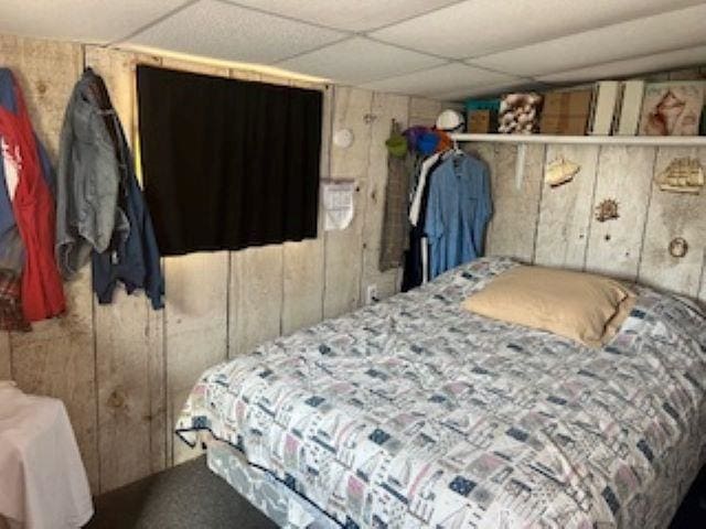 75 W Boardwalk, Grassy Sound, NJ 08260 - bedroom featuring wooden walls and a drop ceiling