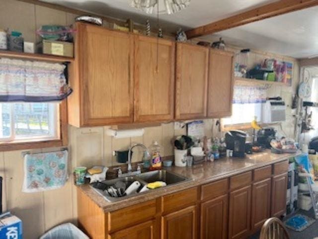 75 W Boardwalk, Grassy Sound, NJ 08260 - kitchen featuring light countertops, brown cabinets, and beam ceiling