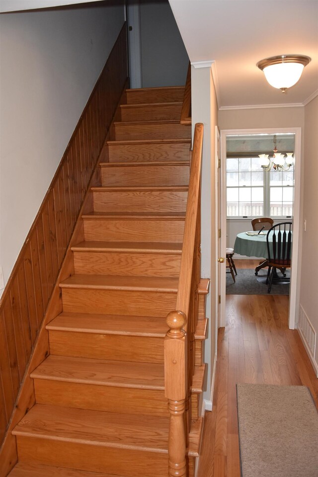 7 Corson Ln, Ocean View, NJ 08230 - stairs featuring crown molding, wood finished floors, a chandelier, and baseboards