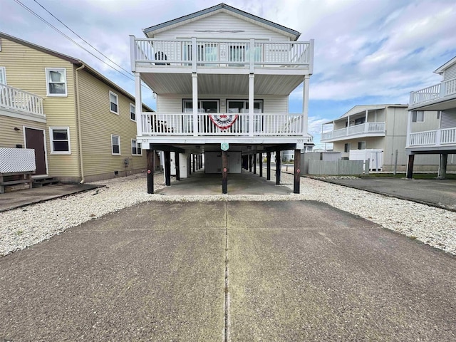 raised beach house with a carport and a balcony