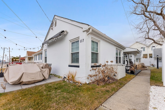 view of side of home with a lawn