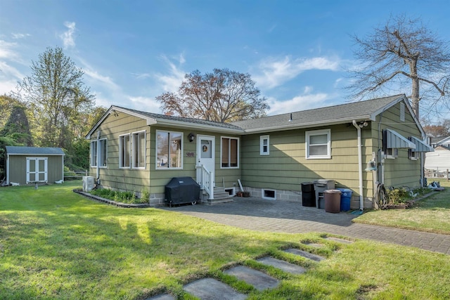 36 W Virginia Ave, Villas, NJ 08251 - rear view of house featuring an outdoor structure, entry steps, a patio area, a shed, and a lawn