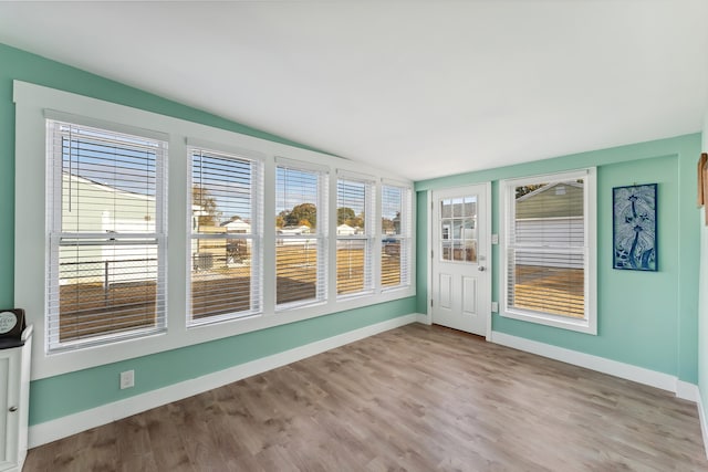 unfurnished sunroom with vaulted ceiling