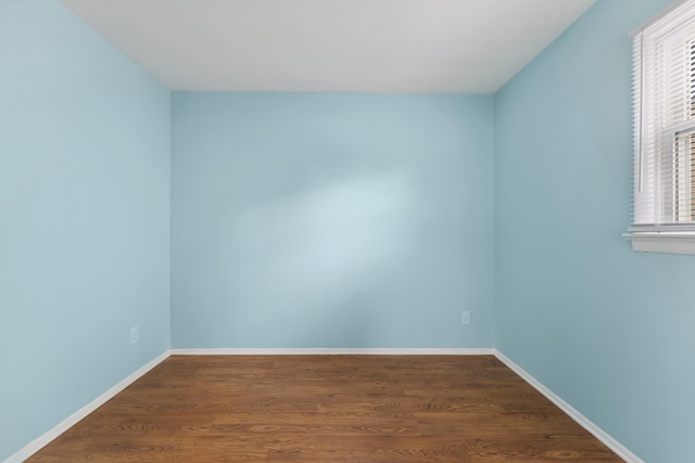 empty room featuring dark wood-type flooring