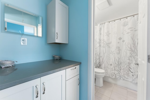 full bathroom with tile patterned flooring, vanity, toilet, and shower / bath combo with shower curtain