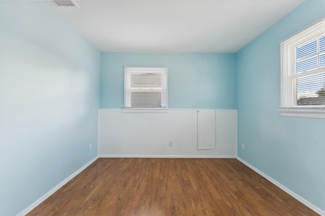 unfurnished room with hardwood / wood-style floors