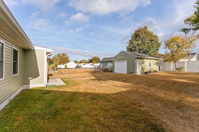 view of yard with a garage and an outdoor structure