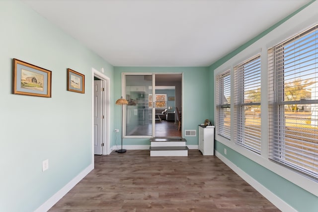 hall with dark wood-type flooring