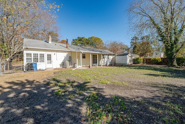 202 Pacific Ave, Palermo, NJ 08223 - back of house featuring fence, a lawn, a chimney, a storage shed, and an outbuilding