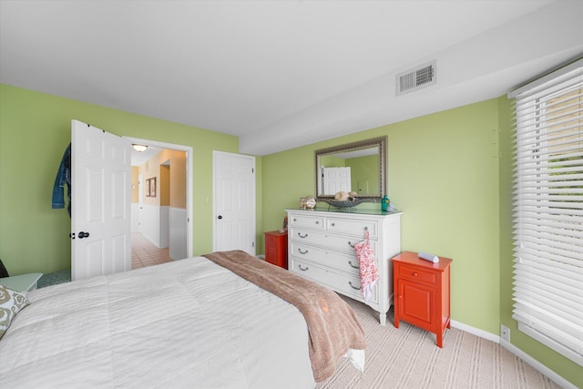 bedroom featuring light carpet, baseboards, and visible vents