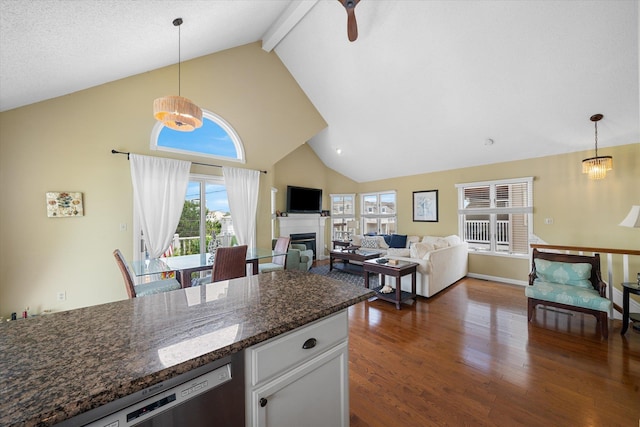 kitchen featuring hanging light fixtures, dark wood-type flooring, a glass covered fireplace, white cabinets, and dishwasher