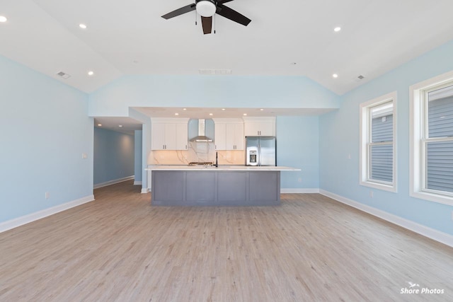 403 E Glenwood Ave Unit 15, Wildwood, NJ 08260 - kitchen featuring stainless steel fridge, wall chimney exhaust hood, lofted ceiling, open floor plan, and white cabinets