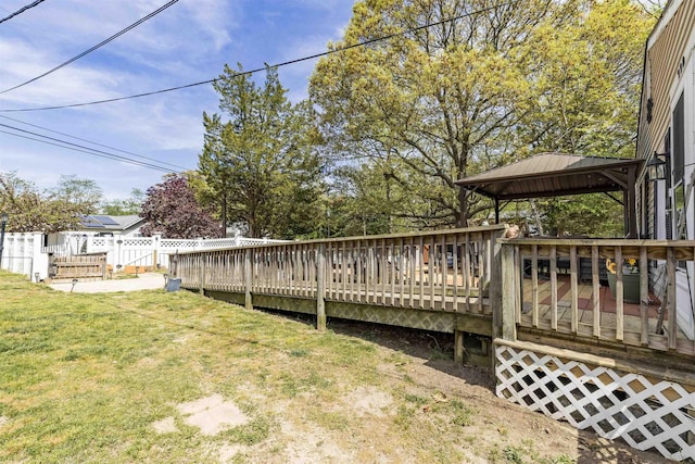deck with a gazebo, a lawn, and fence