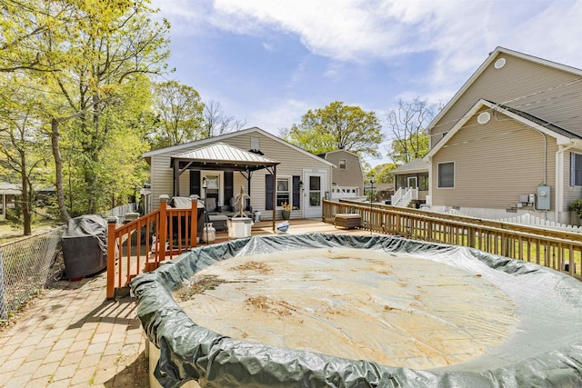 deck with a gazebo and a fenced backyard