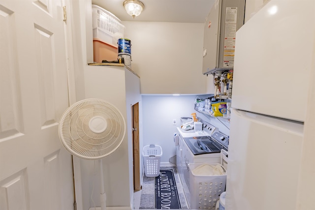 laundry area with washer and dryer, laundry area, and tankless water heater