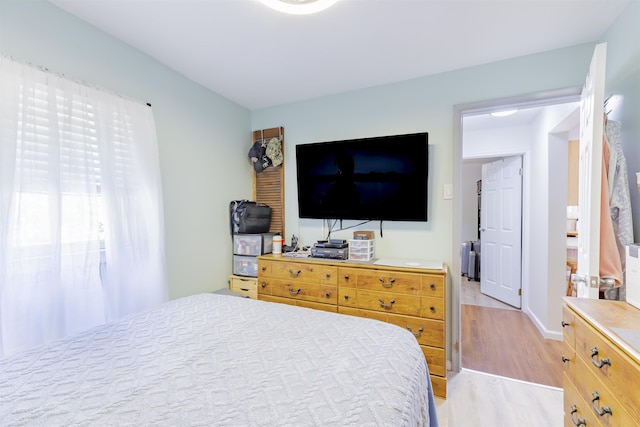 bedroom with baseboards and light wood-style flooring