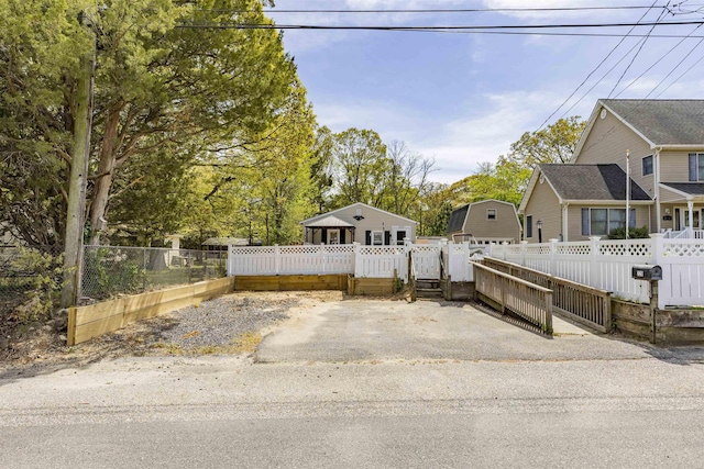 view of front of property featuring fence and a gate